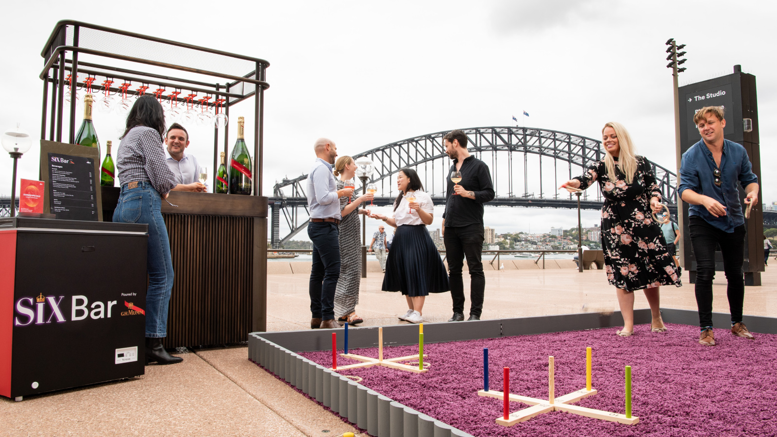 People having fun outside a bar, playing games.