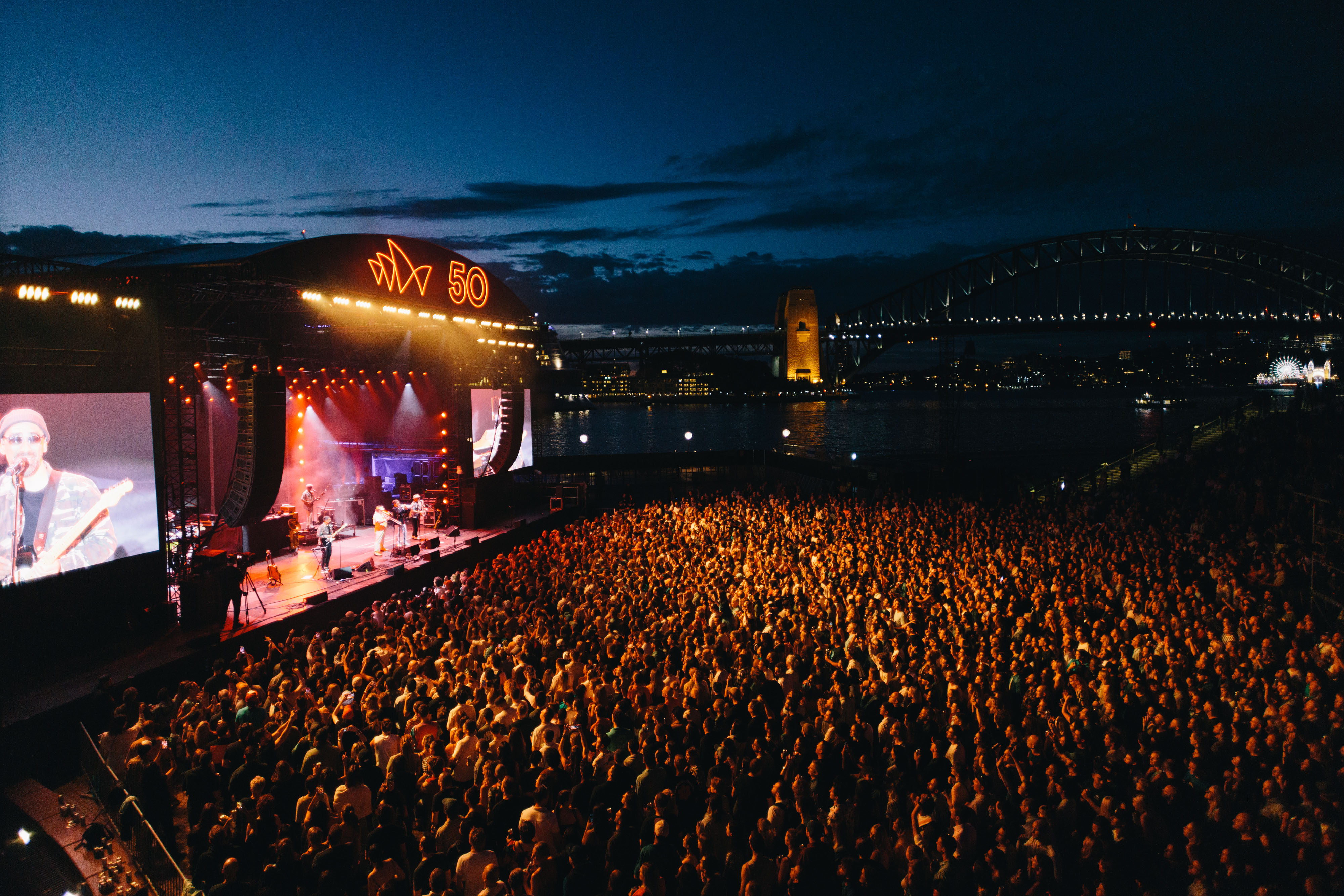 A crowd of people attending a musical concert.