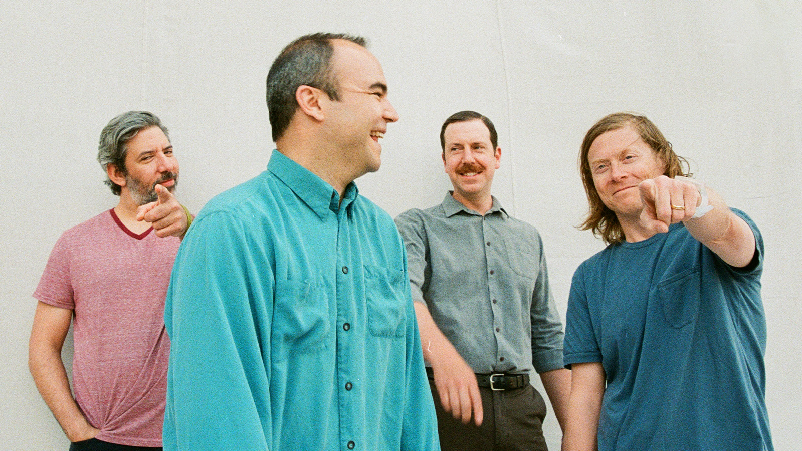 Four men from a pop band Future Islands standing together.