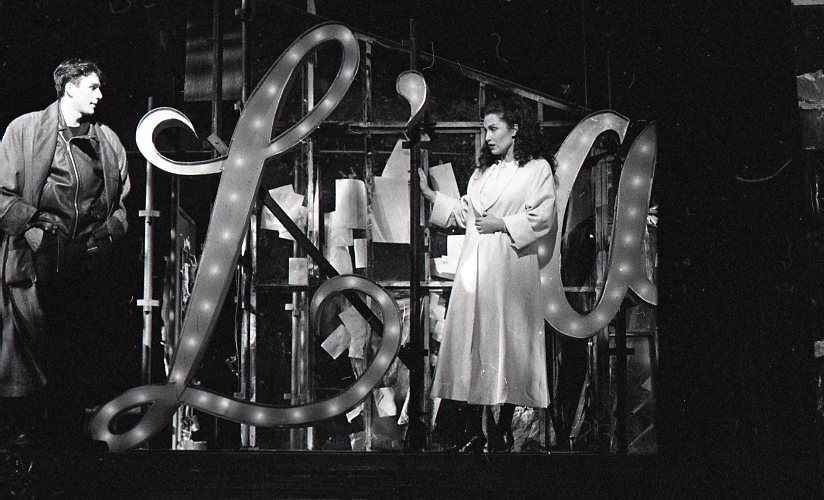 A man and a woman performing Opera on the stage.