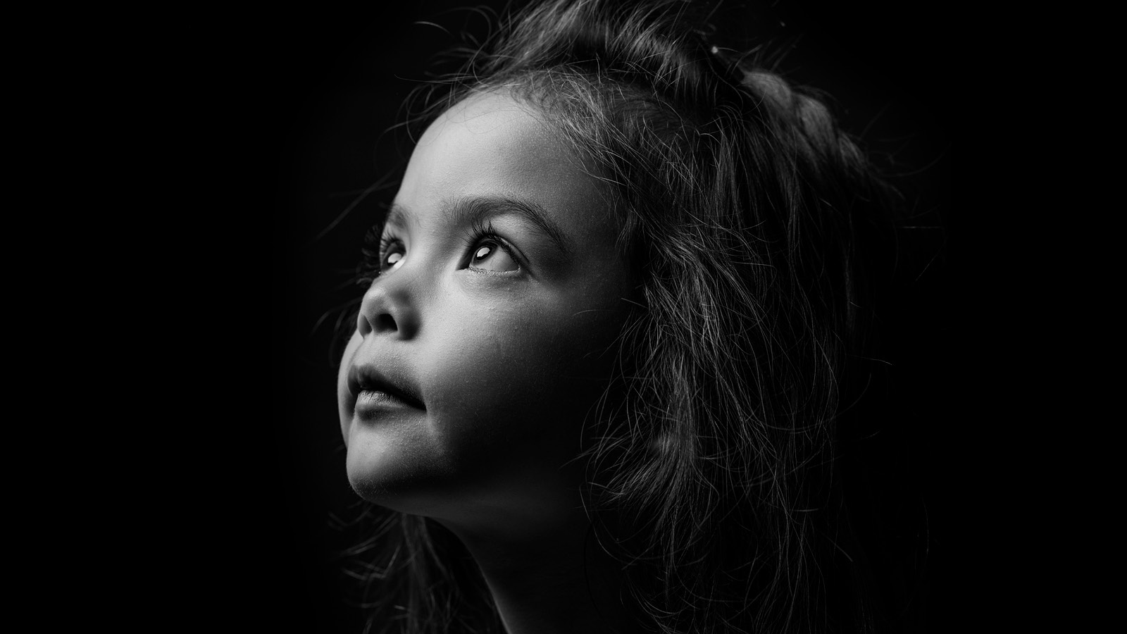 A girl looking at the sky.