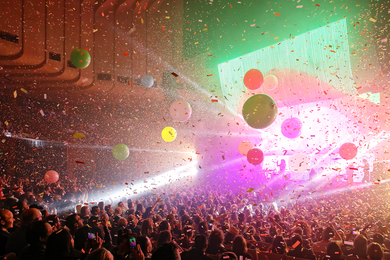 A crowd of people in the Concert Hall enjoying a performance.