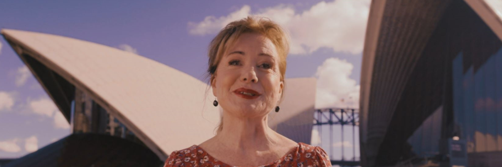 Bernadette Robinson stands in front of the Opera House sails