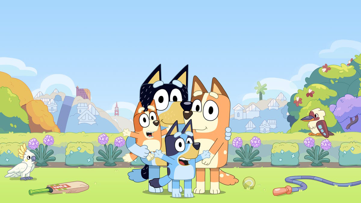 Four cartoon dogs gathered together in a field.