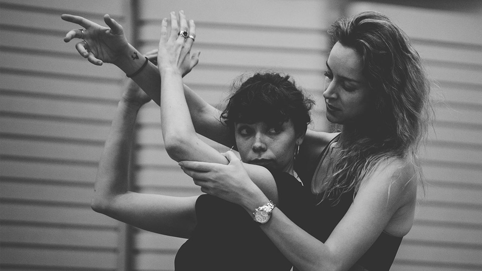 Two women dancing in a studio.