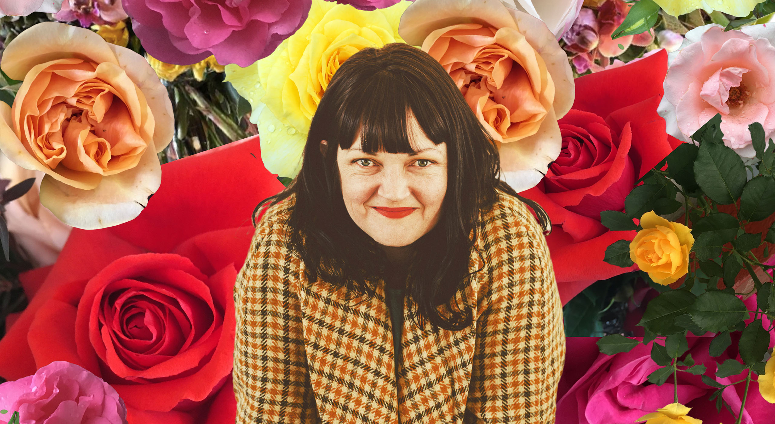 A women smiling infront of a background of flowers