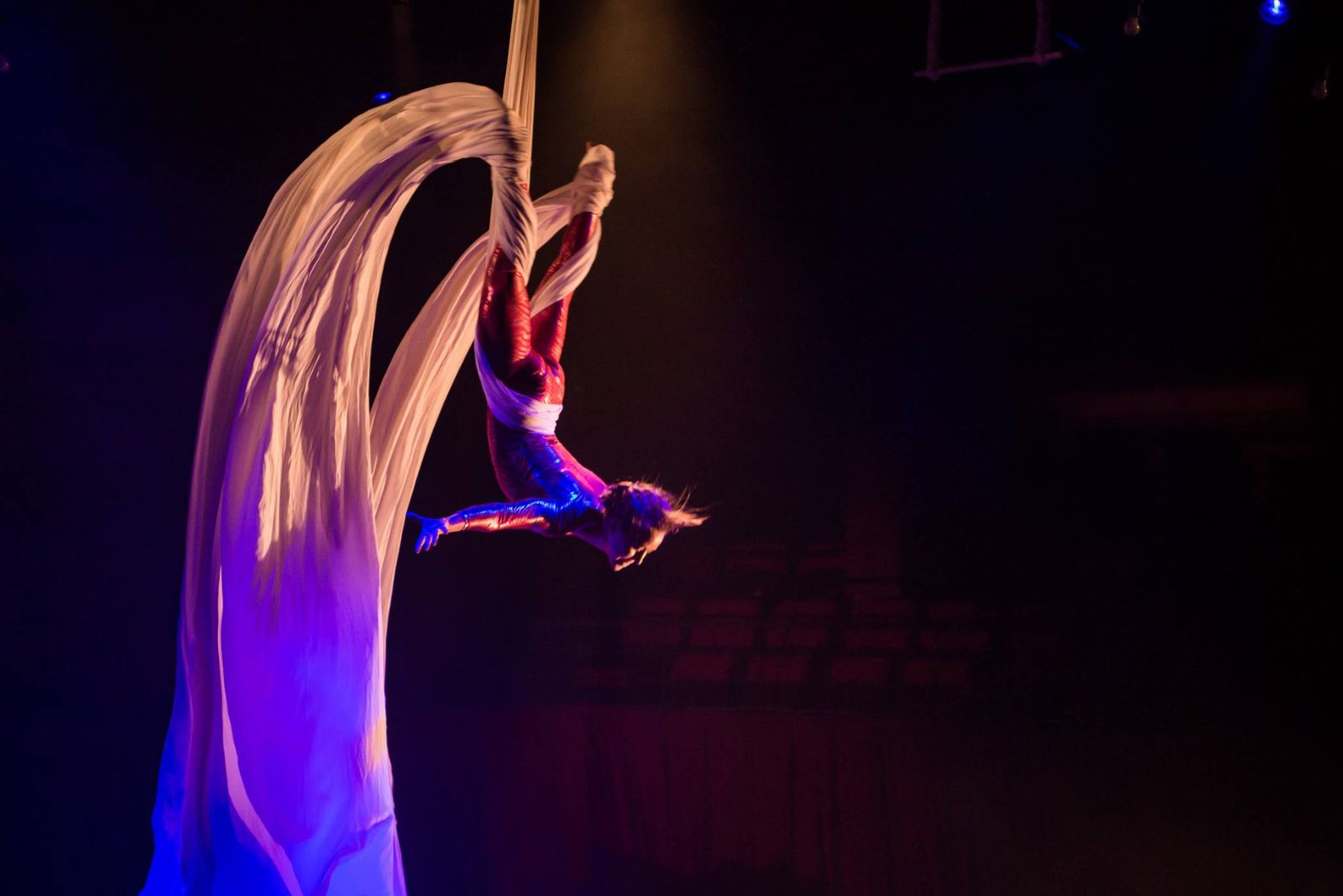 A woman performing stunt in the circus.