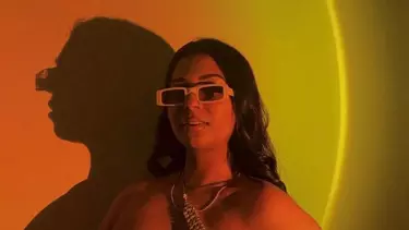 A woman with black hairs, wearing sunglasses.