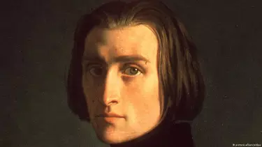 A man with slick back long hair and a chiseled jaw.