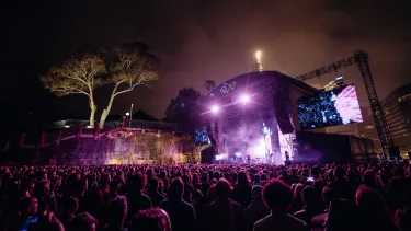 Concertgoers at a show in front of the Sydney Opera House.
