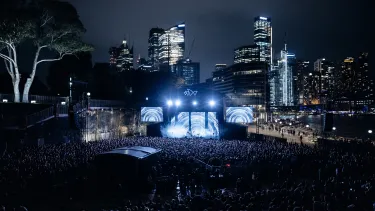 Concertgoers at a show outside in front of the Sydney Opera House.
