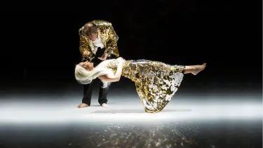 A man putting a flower on a floating woman.