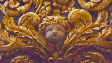 A golden cherub and flowers wood carving.