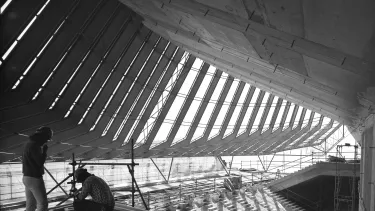 Two men working on the interior construction of the Sydney Opera House.