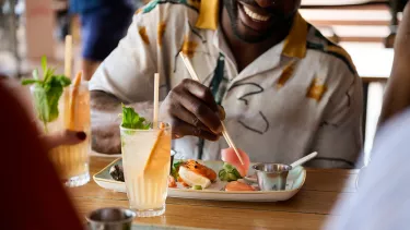 A man enjoying food at the Opera bar.