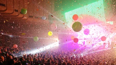 A crowd of people in the Concert Hall enjoying a performance.