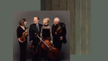 A group of musicians in black holding their instruments.