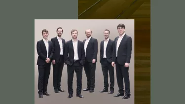 A group of six men in black suit.