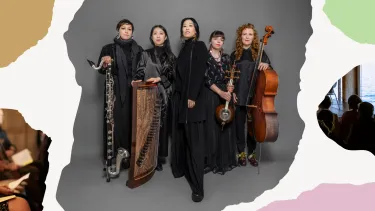 Five female musicians in black attire stand confidently against a gray backdrop. They hold various instruments, including a bass clarinet, global string instruments, and cello.