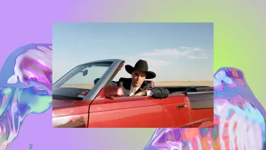 A man wearing a cowboy hat and suit sits in a red convertible.
