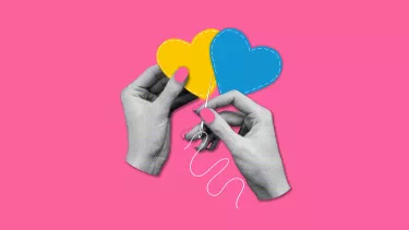 Two hands sewing together hearts.