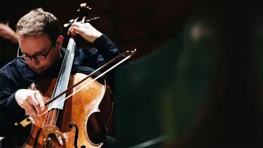 A man playing a cello.