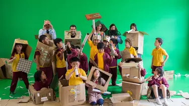 Educators and the kids playing with cardboard.