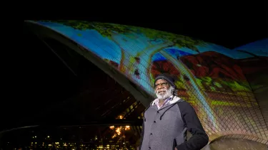 A man stood outside the Sydney Opera House's sails.