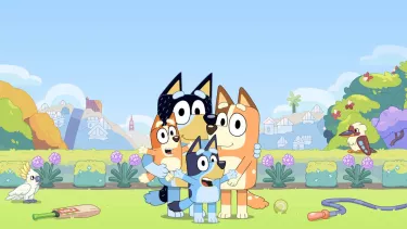 Four cartoon dogs gathered together in a field.