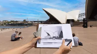A hand drawn picture of the Sydney Opera House on a clipboard
