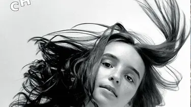 A woman with her hairs flying in the air.