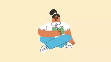 An illustration of a girl sitting cross-legged, smiling and reading a book.