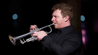 Brent Grapes plays the trumpet.