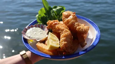 Coral trout fish and hand cut chips on a plate.