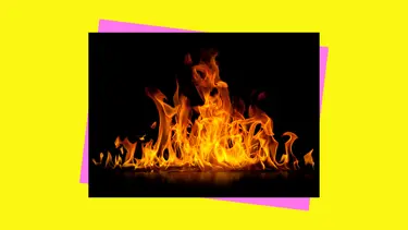A bright orange and red fire against a black backdrop