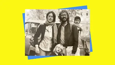 An old sepia family portrait. A man is seen with his arm around a woman. The man has an infant on his back, and a toddler stands between them.
