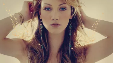 Delta Goodrem a blonde Australian singer in a white dress.