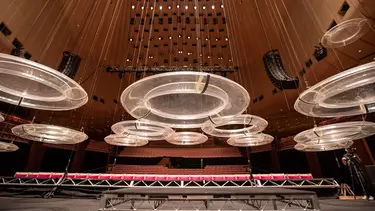 Looking up at many clear perspex discs hanging from the ceiling of the Concert Hall.