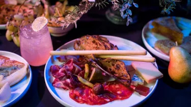 A table with appetizers and cocktails.