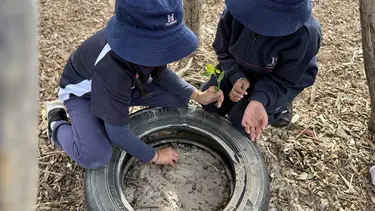 East Derwent school children gather in a forest.