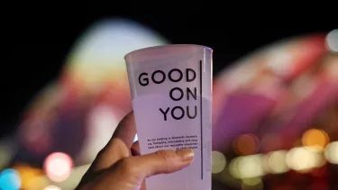 A person holding a drink.
