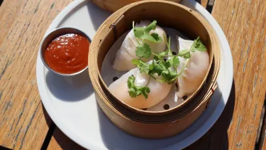 A plate of seafood dumplings on a table.
