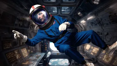 Woodley floating in fake spaceship in his blue astronaut suits, looking concerned and pointing at something heading into space