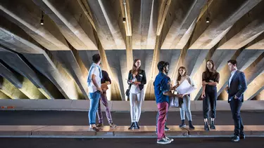 A group of men and women having a discussion.