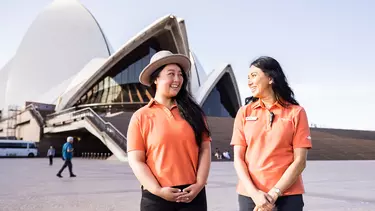 Two women from welcome team outside Sydney opera house.