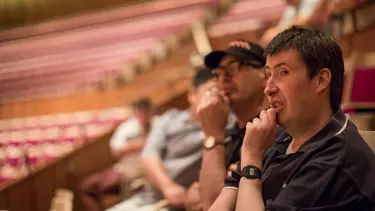 Two men sitting in the Concert Hall.