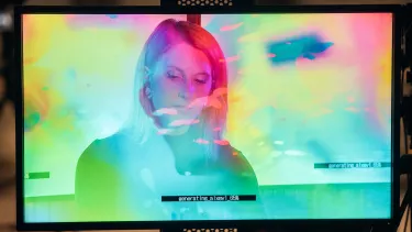 A screen displaying an image of a person with multicoloured areas