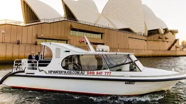 A boat outside of the Sydney Opera House.