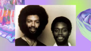 Vintage photo of two black men smiling, one has a tall afro hairstyle and thick beard. The background is an iridescent purple swirl, looking like water.