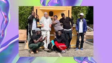 A group of seven people pose casually in front of a wooden structure. The image overlays a backdrop of a purple, iridescent swirl, looking like water.